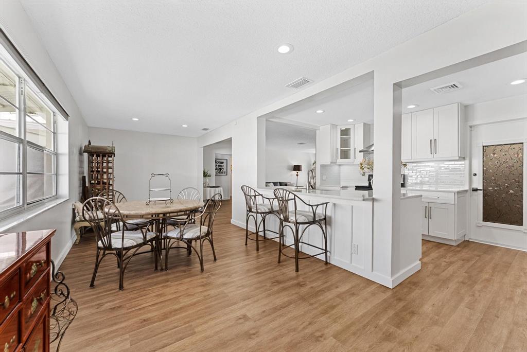 1001 Southwest 6th Avenue Boynton Beach, FL 33426 - Photo 12 of 31 a view of a dining room with furniture and wooden floor
