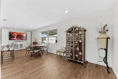 a kitchen with stainless steel appliances white cabinets and wooden floor