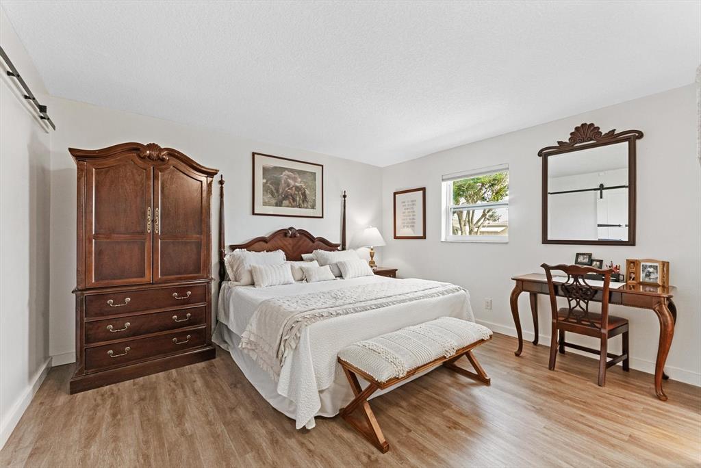 1001 Southwest 6th Avenue Boynton Beach, FL 33426 - Photo 15 of 31 a bedroom with a bed a table and chair