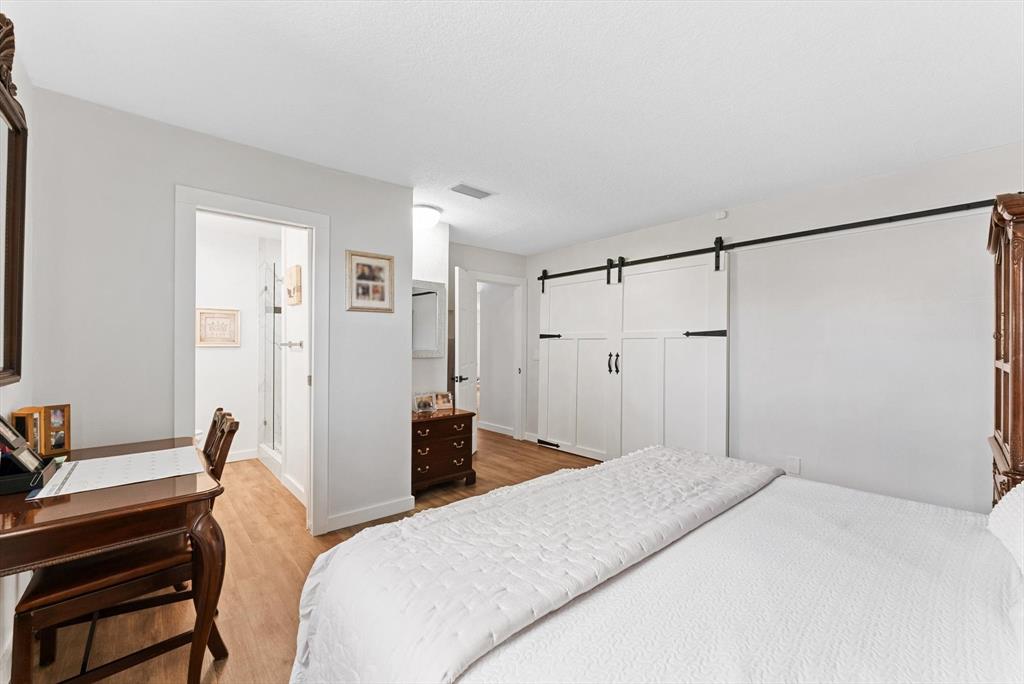 1001 Southwest 6th Avenue Boynton Beach, FL 33426 - Photo 16 of 31 a bedroom with a bed and a chandelier