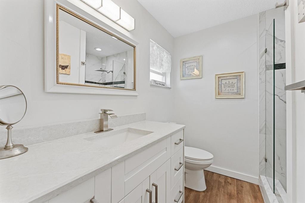 1001 Southwest 6th Avenue Boynton Beach, FL 33426 - Photo 17 of 31 a bathroom with a toilet sink and mirror