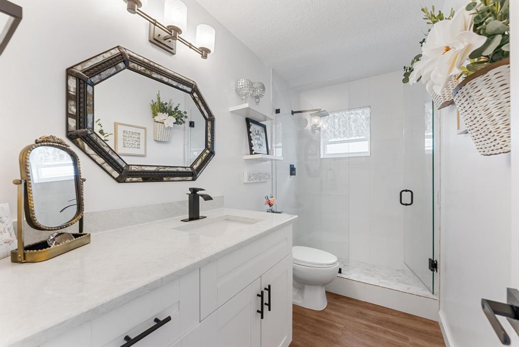 1001 Southwest 6th Avenue Boynton Beach, FL 33426 - Photo 20 of 31 a bathroom with a toilet a sink and a mirror