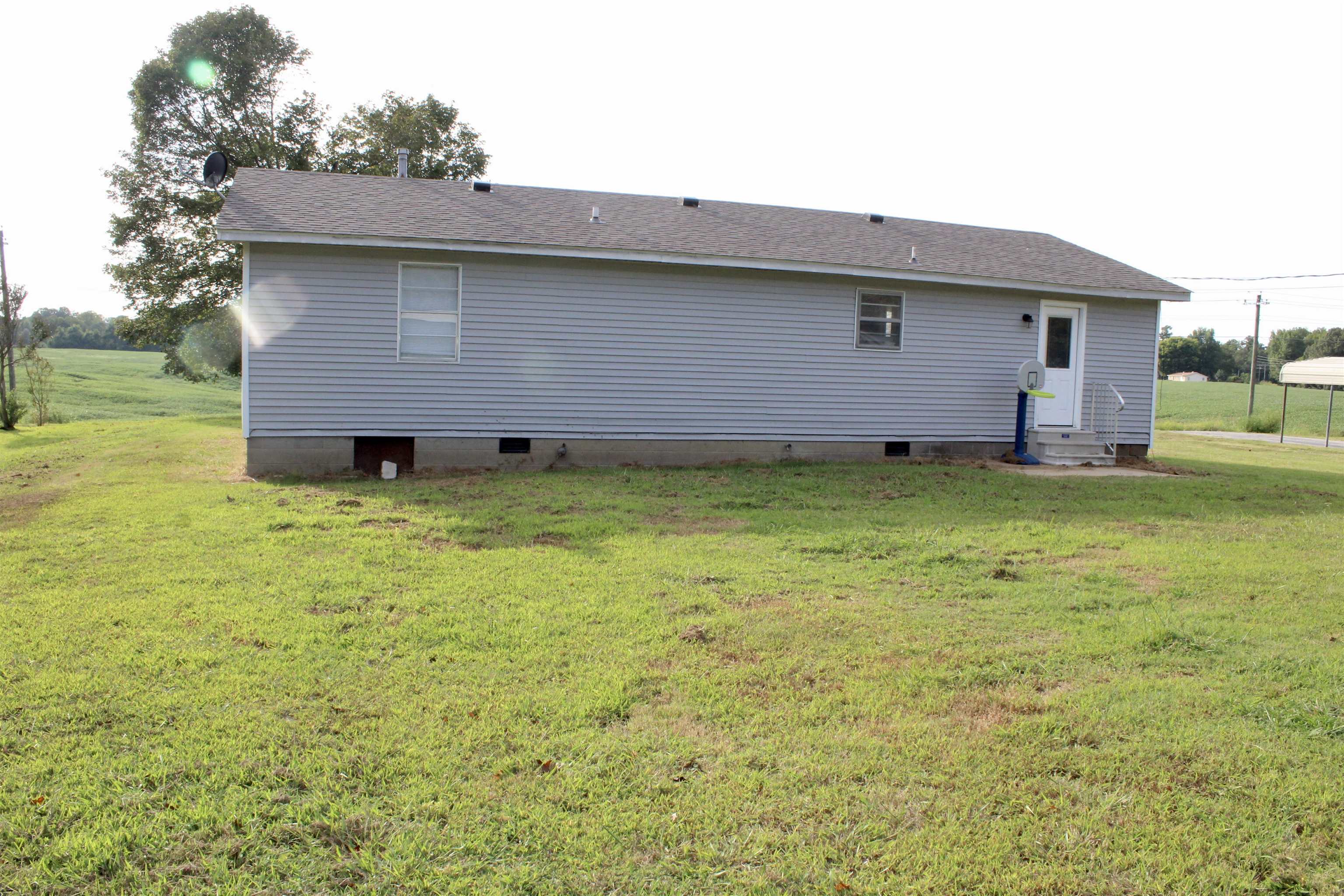 1832 Curve Nankipoo Road Ripley, TN 38063 - Photo 15 of 18 a backyard of a house with yard table and chairs