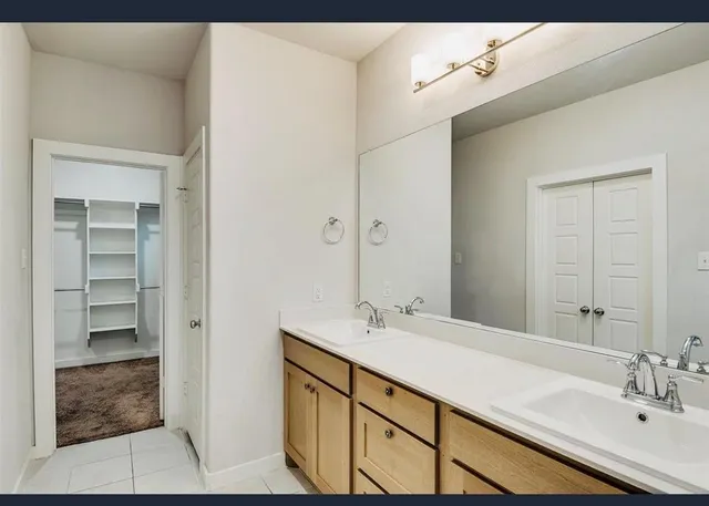 a bathroom with a sink shower and a mirror