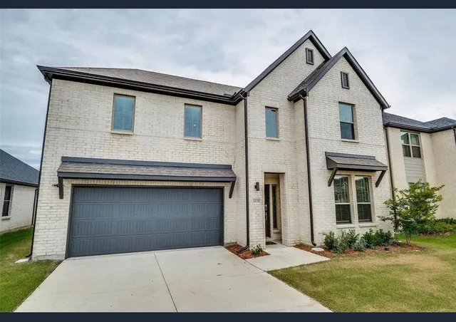 a front view of a house with garage