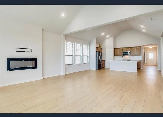 a view of a kitchen with a sink cabinets and a refrigerator