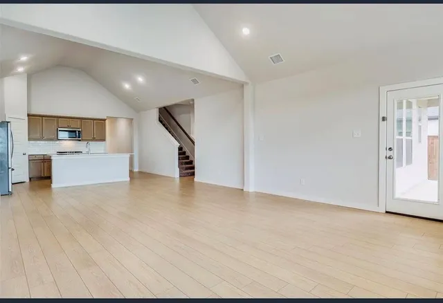 a view of a livingroom with an empty space and a fireplace