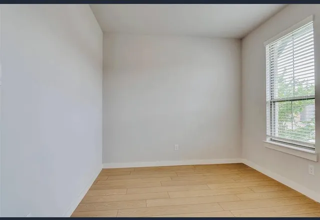a large kitchen with granite countertop a refrigerator and a sink