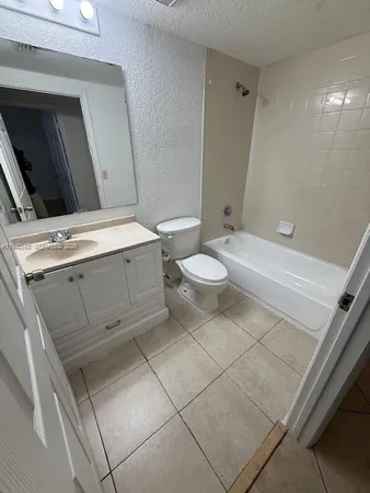 a bathroom with a toilet a sink and bathtub