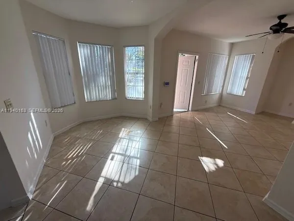 a view of an empty room with windows