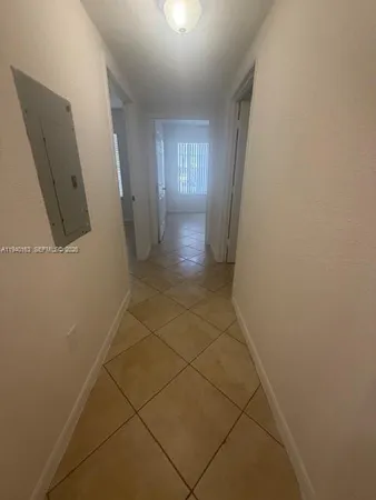 a view of hallway with window and stairs