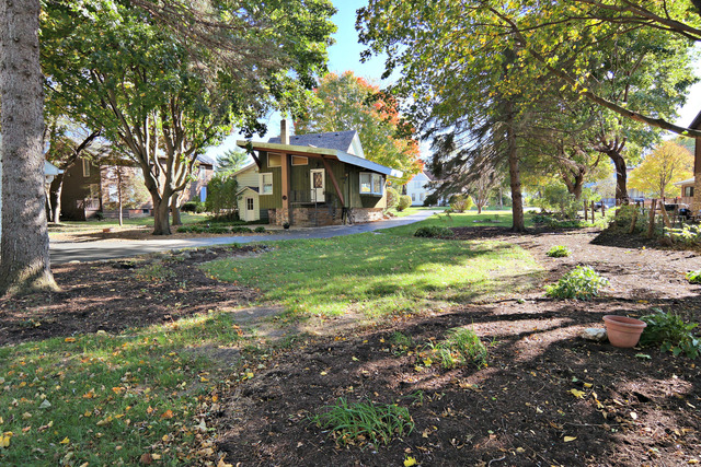 11814 Maple Avenue Hebron, IL 60034 - Photo 15 of 20 a front view of a house with a yard and trees