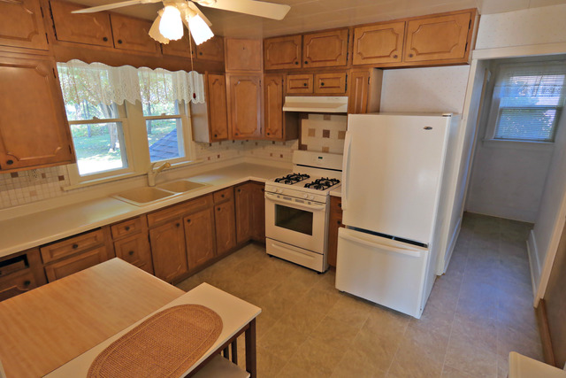11814 Maple Avenue Hebron, IL 60034 - Photo 8 of 20 a kitchen with stainless steel appliances a stove a refrigerator a sink and white cabinets