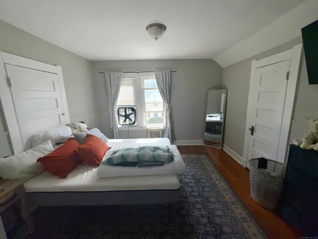 a bedroom with a large bed and a dresser