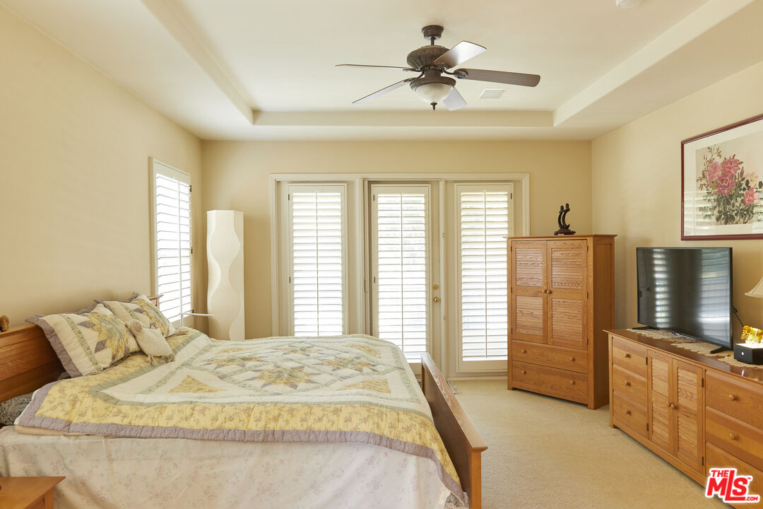 6 Mountainbrook Irvine, CA 92620 - Photo 14 of 31 a spacious bedroom with a bed a dresser and floor to ceiling window