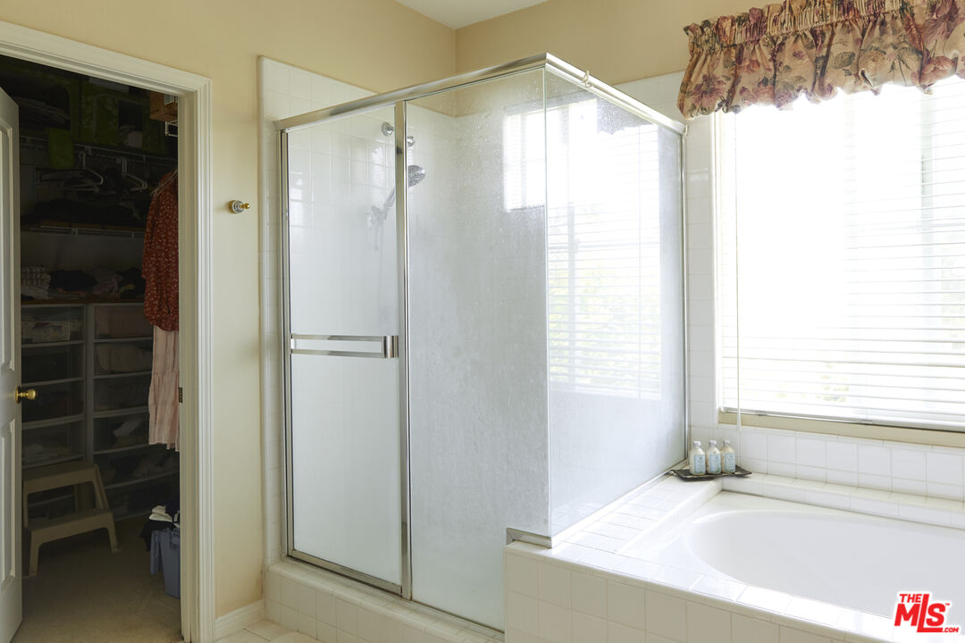 6 Mountainbrook Irvine, CA 92620 - Photo 17 of 31 a bathroom with a bathtub and a shower