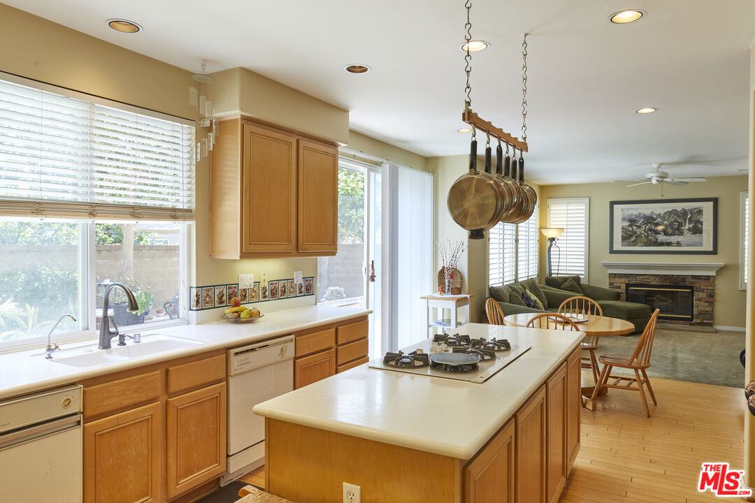 6 Mountainbrook Irvine, CA 92620 - Photo 7 of 31 a kitchen with a sink a stove and chairs