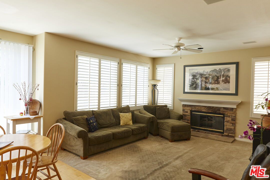 6 Mountainbrook Irvine, CA 92620 - Photo 8 of 31 a living room with furniture a large window and a fireplace