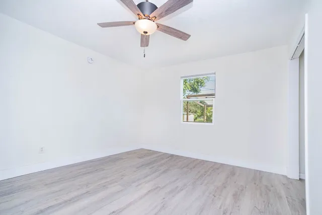 a view of an empty room with a fan