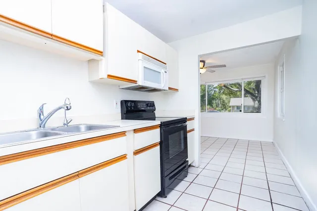 a kitchen with stainless steel appliances granite countertop a sink and a stove