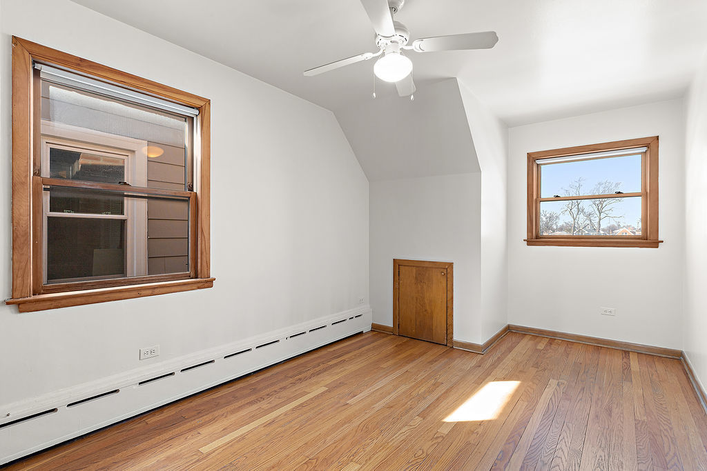 5353 North Nottingham Avenue Chicago, IL 60656 - Photo 12 of 20 a view of an empty room with wooden floor and a window