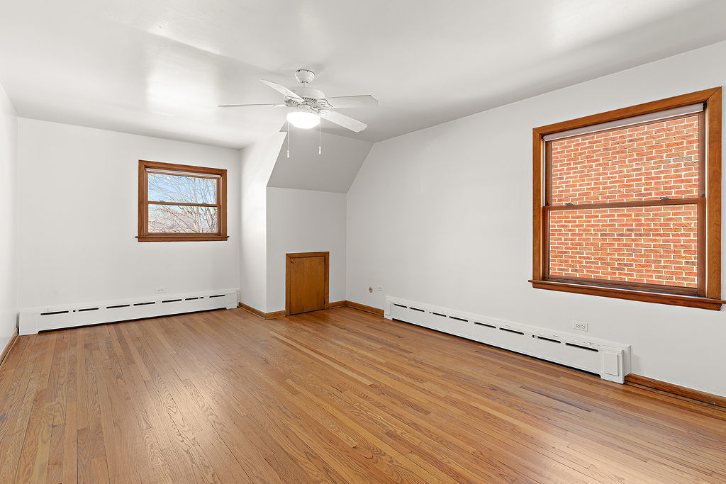 5353 North Nottingham Avenue Chicago, IL 60656 - Photo 8 of 20 a view of an empty room with wooden floor and a window