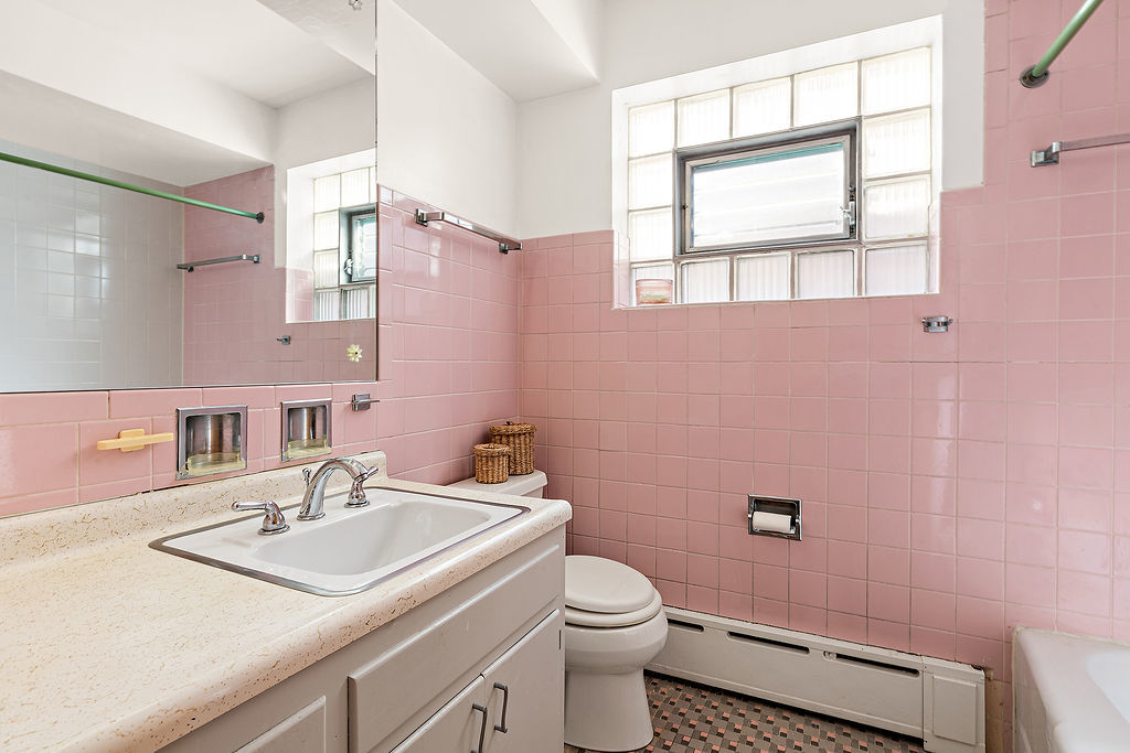 5353 North Nottingham Avenue Chicago, IL 60656 - Photo 10 of 20 a bathroom with a sink a toilet and a window
