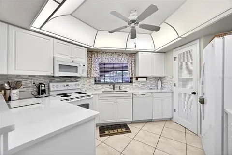 a kitchen with cabinets a sink and appliances