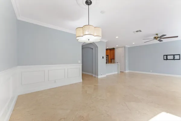 a view of an empty room with a chandelier