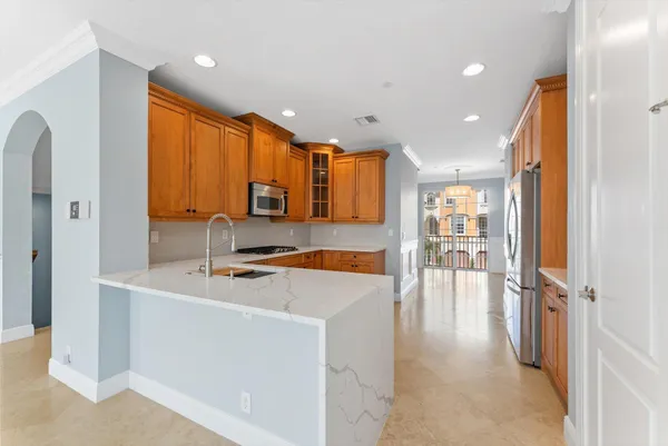 a large white kitchen with a large window
