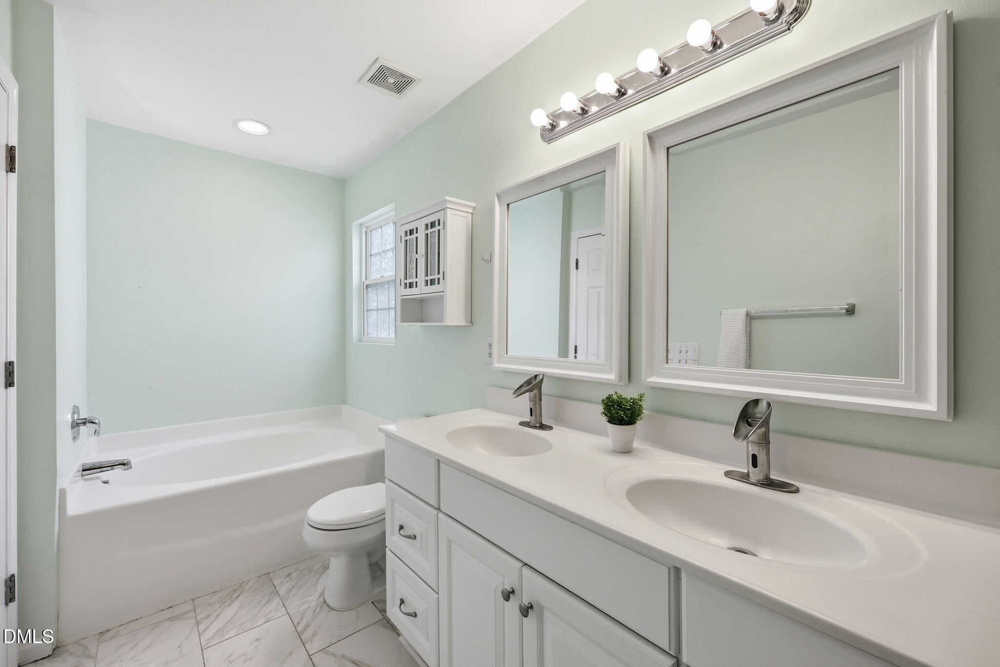 4232 Dalcross Road Raleigh, NC 27610 - Photo 22 of 42 a bathroom with a tub a sink and mirror