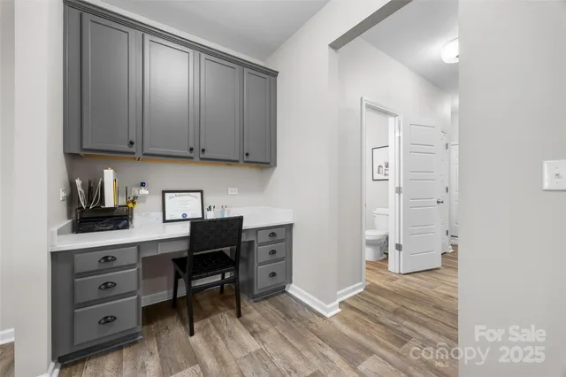 a view of a workspace with furniture and cabinet