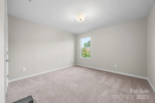 a view of an empty room and a window