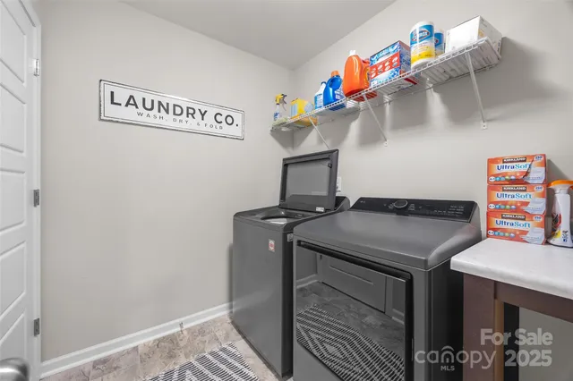 a view of a patio with a table and chairs and wooden fence