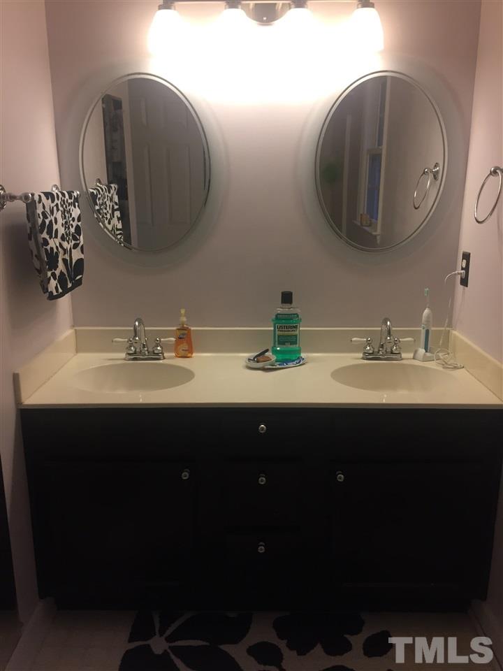 4300 Riverport Road Raleigh, NC 27616 - Photo 1 of 2 a bathroom with a double vanity sink and a mirror