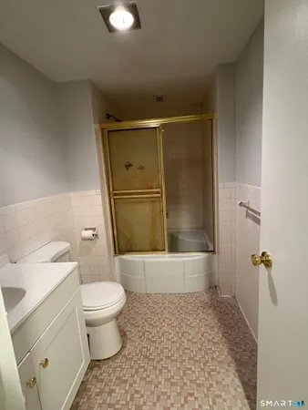a bathroom with a toilet and a shower