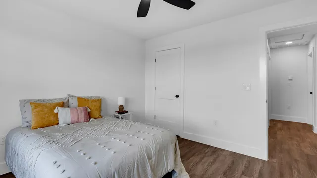 a bedroom with a bed and wooden floor
