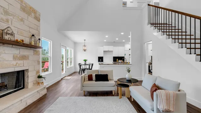a living room with furniture a fireplace and a flat screen tv
