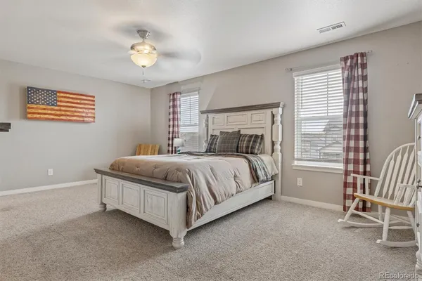 a bedroom with a bed and a chair