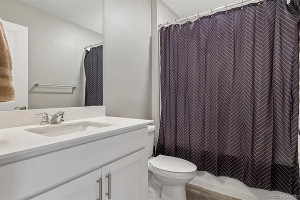 a bathroom with a sink toilet and mirror