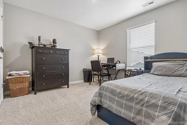 a bedroom with a bed and a dresser