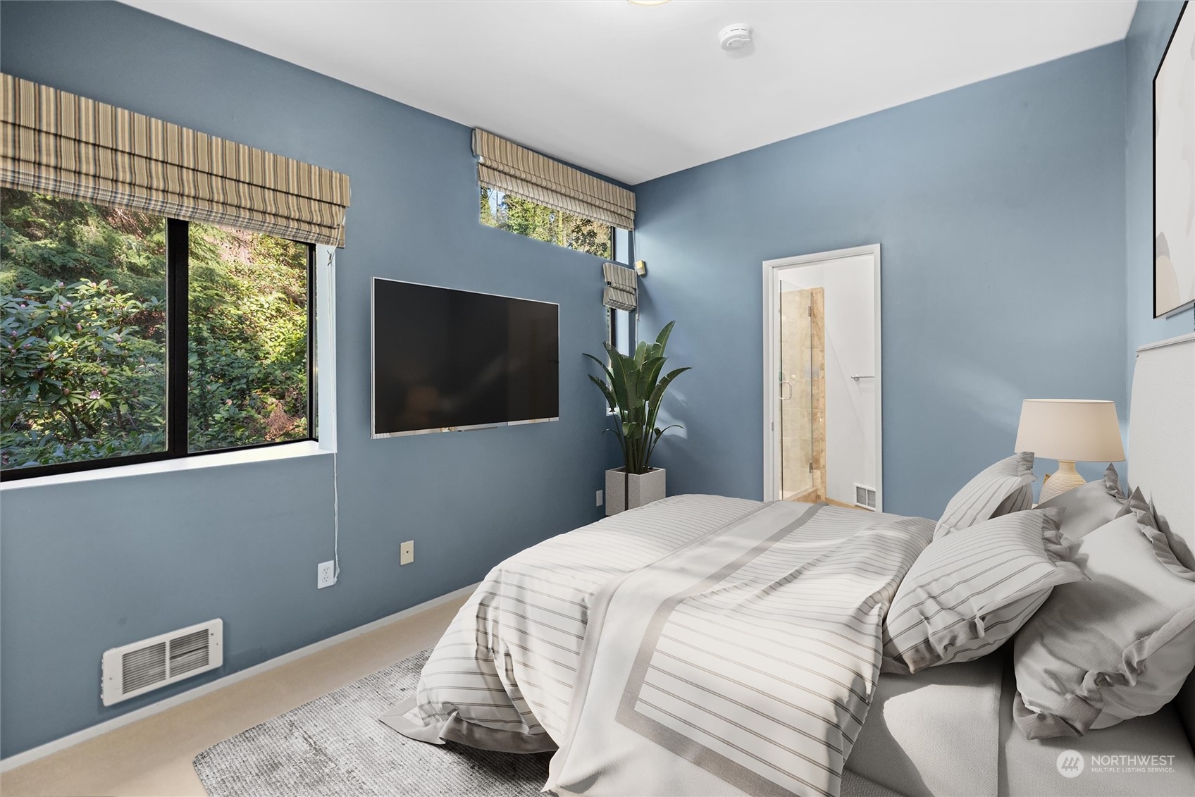 3 Lindley Road Mercer Island, WA 98040 - Photo 21 of 37 a bedroom with a bed and a flat screen tv