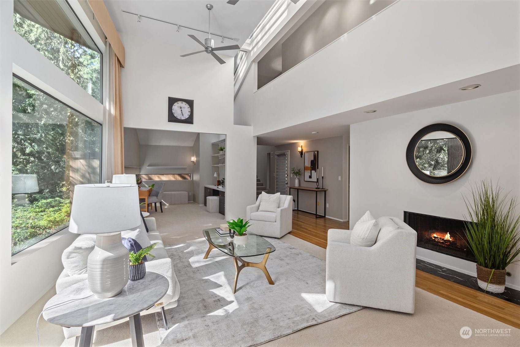 3 Lindley Road Mercer Island, WA 98040 - Photo 4 of 37 a living room with furniture a clock on wall and a large window