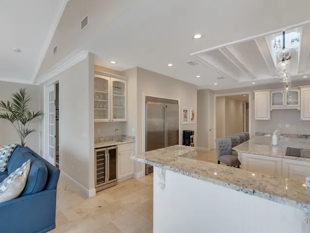 a living room with furniture a flat screen tv and a window