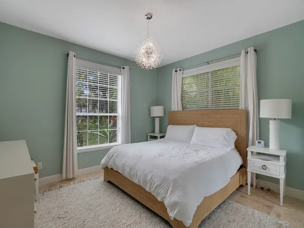 a bathroom with a granite countertop sink a toilet a mirror and shower