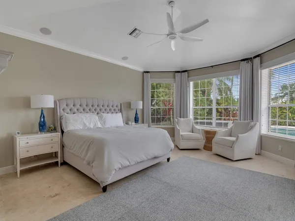 a spacious bedroom with a large bed and a large window