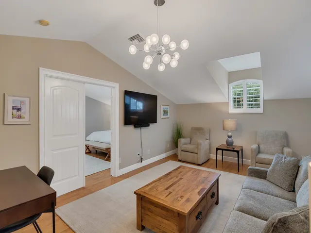 a bed room with a bed and a chandelier