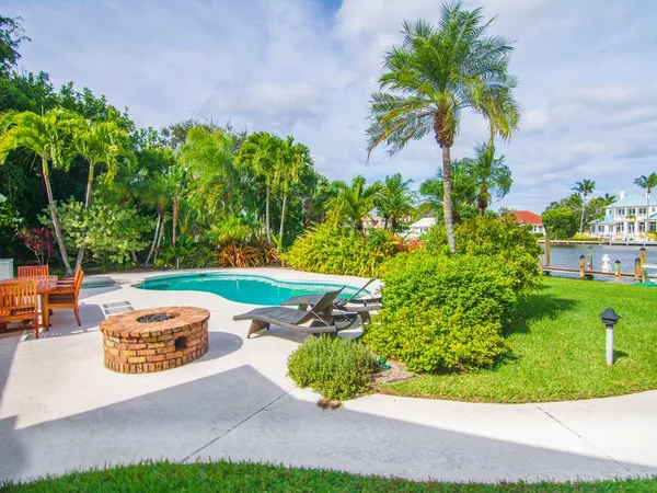 a view of a fountain in front of a house with a big yard