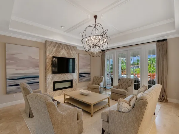 a living room with furniture wooden floor and a chandelier