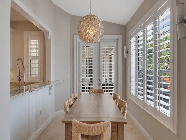 a living room with furniture a fireplace and a chandelier